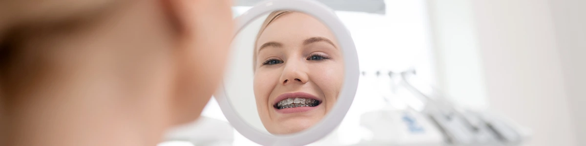 image-young-woman-smiling-looking-in-the-mirror image young woman smiling looking in the mirror